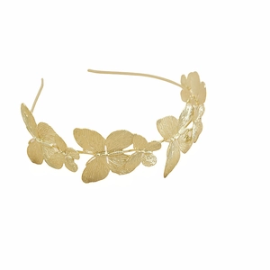 Detailed view of golden butterfly headband featuring textured metal wings in a row