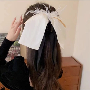 Elegant French bow hair clip with white feathers and long black ribbons for women