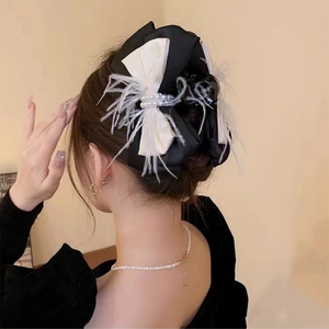 Elegant large bow hair clip with white feathers and pearls on black satin for women