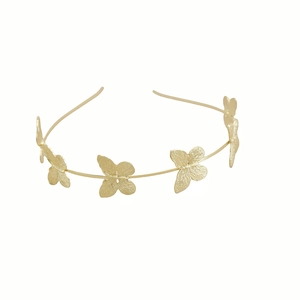 Detail of five golden metal butterflies with realistic wing textures on a slim headband