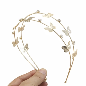 Close-up of golden double-layer headband with hollow butterflies and crystals