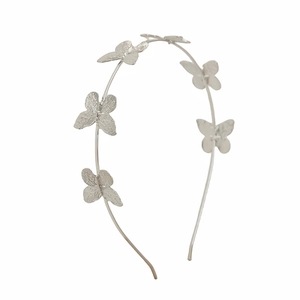 Detailed view of silver butterfly headband with five textured metal ornaments for women
