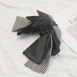 Classic houndstooth bow hair clip with black satin layers and pearl accent for women