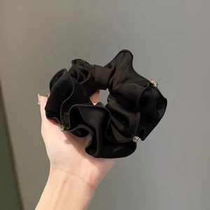 Elegant black satin scrunchie with sparkling rhinestones for stylish ponytails