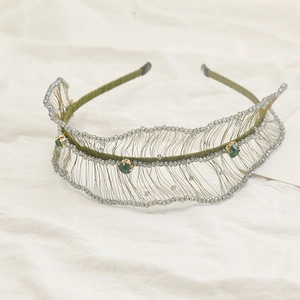 Luxurious green crystal beaded headband with woven mesh and emerald gemstone accents