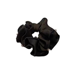 Elegant black satin scrunchie with silver bead accents for stylish ponytail hair styling