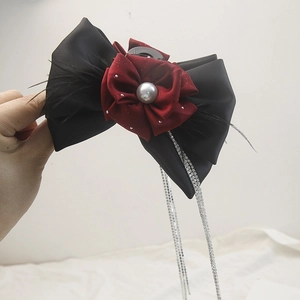 Elegant floral hair claw with black ribbon and shimmering rhinestone fringe tassels