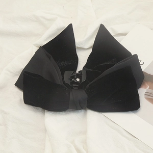 Detail view of the black velvet bow hair claw clip with dual fabric layers and secure grip
