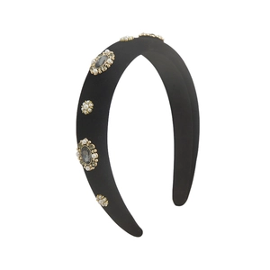 Baroque style velvet headband with grey gemstones and white pearls on a white background