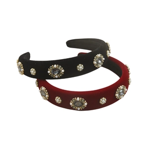 Detailed macro of vintage velvet headbands with pearls and rhinestones on white background
