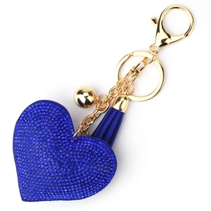 Detail of blue rhinestone heart keychain with matching tassel and gold bell pendant