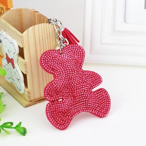 Close-up of rose red rhinestone bear keychain with silver metal ring and red tassel