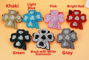 Array of colorful rhinestone clover keychains with tassels in seven various colors