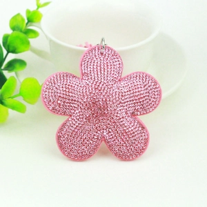 Pink floral faux crystal keychain with silver ring and stylish tassels on white background