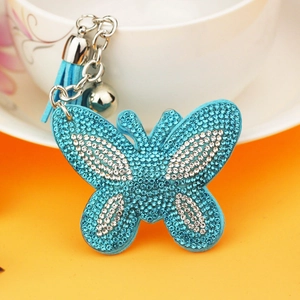 Glinsterende vlinder sleutelhanger met blauwe strass-steentjes en een blauwe kwastje