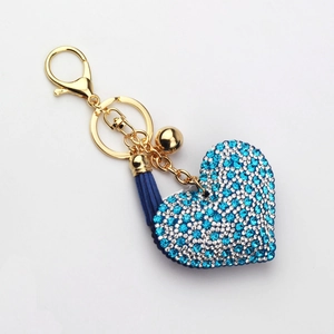 Detail of blue and white rhinestone heart keychain with gold hardware and blue tassel
