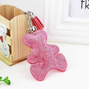 Detail of pink crystal-studded bear keychain with matching tassel and silver metal ring