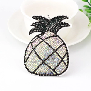 Close-up of a sparkling rhinestone pineapple pendant with black and AB crystal stones