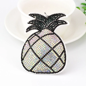 Sparkling crystal pineapple keychain charm with colorful rhinestones on a white background