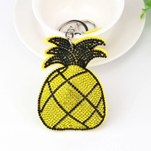 Detailed macro view of pineapple keychain with yellow rhinestones and silver lobster clasp