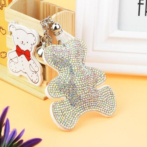 Close-up of cute bear keychain with AB colorful rhinestones and silver bell charm