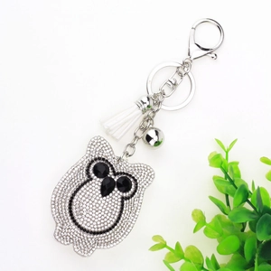 Close-up of owl keychain with silver rhinestones, white tassel and lobster clasp detail