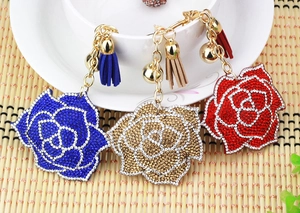 Detailed view of luxury rose keychains with rhinestones, bells, and matching tassels
