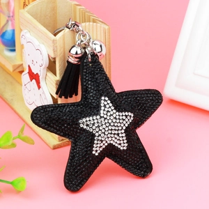 Close-up of black star keychain with glittering rhinestones and elegant tassel detail