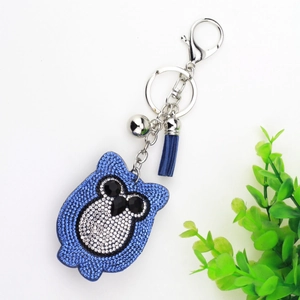 Detailed view of navy blue velvet owl keychain with sparkling rhinestones and matching tassel