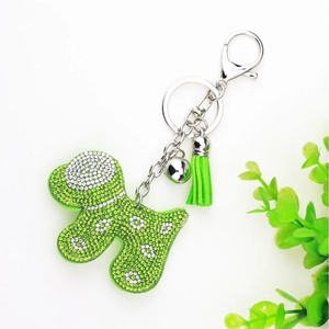 Detail of green rhinestone dog keychain with elegant matching tassel and silver hardware