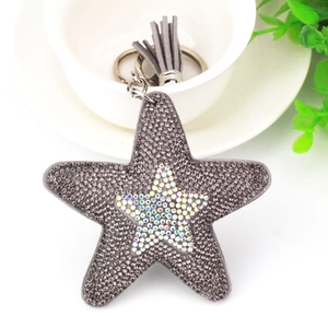 Detailed macro view of the sparkling star keychain with grey rhinestones and suede tassel
