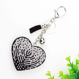 Porte-clés cœur tendance avec strass noirs, clochette argentée et pompon en cuir