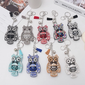Detailed assortment of sparkling rhinestone owl keychains with tassels and bells