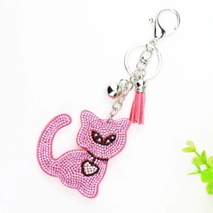Pink rhinestone cat keychain with soft tassel and silver bell detail on white background