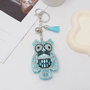 Light blue cartoon owl keychain with rhinestones, silver bell and tassel charm