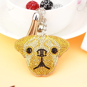 Porte-clés tête de chien en strass dorés avec pampille en cuir et petite cloche