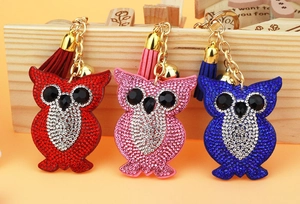 Detailed view of owl keychains with sparkling rhinestones, matching tassels and gold bells