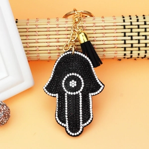 Detail of Hamsa Hand keychain with sparkling rhinestones and elegant black tassel fringe