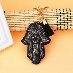 Detailed view of Hamsa Hand keychain with gray rhinestones and a black silk tassel