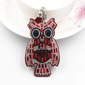 Detail of owl keychain with red rhinestones, silver chain, and matching red tassel