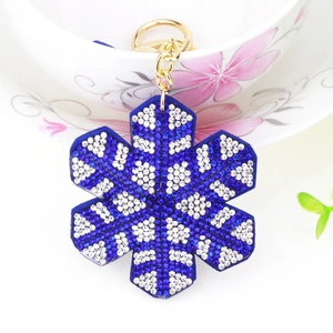 Velvet snowflake keychain with blue and white crystals on a gold keyring
