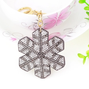 Diamond-encrusted snowflake keychain with velvet base and gold ring for bag decoration