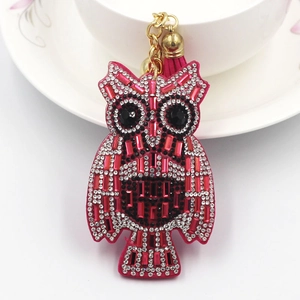 Close-up of fuchsia owl keychain featuring sparkling rhinestones and a silk tassel