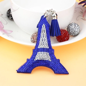 Detailed view of Eiffel Tower keychain featuring blue rhinestones and matching tassel