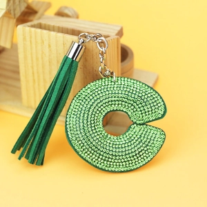 Detail of green letter C keychain with sparkling rhinestones and matching suede tassel