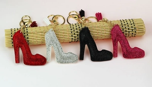 Detail of crystal high heel keychains in red, silver, black and rose gold with tassels