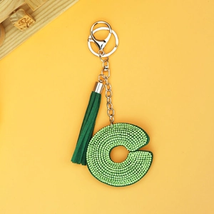 Close-up of green rhinestone letter C keychain with a matching suede tassel and silver clasp