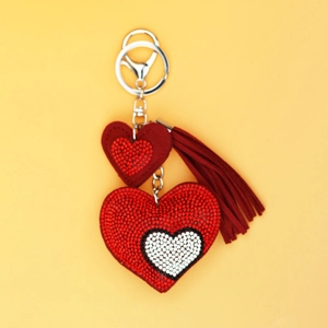 Close-up of sparkling red rhinestone double heart keychain with elegant fringe tassel
