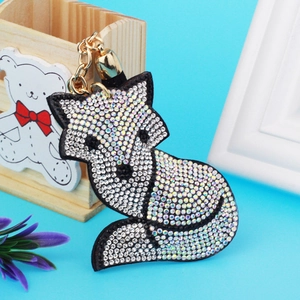 Close-up of fox-shaped keychain with colorful AB rhinestones and golden lobster clasp