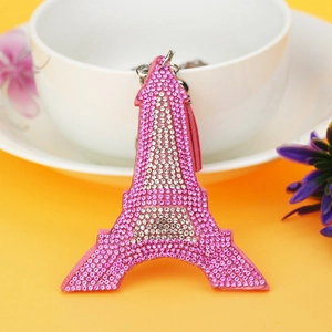 Close-up of pink Eiffel Tower keychain with sparkling rhinestones and matching fringe tassel